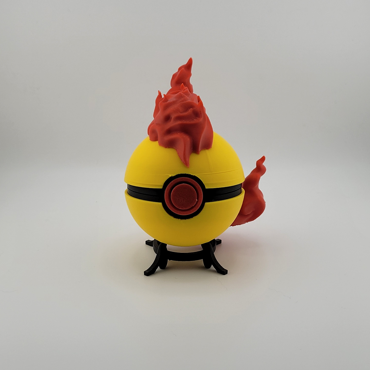 Moltres Pokeball toy with red flame design, pre-order available.