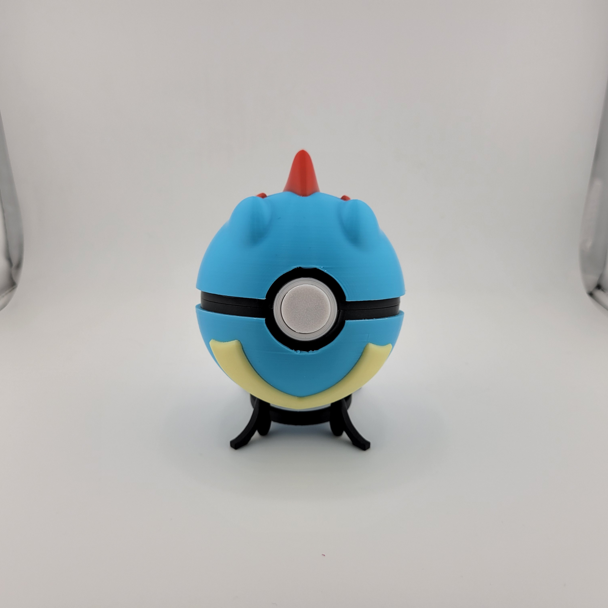 Totodile Pokeball collectible toy on display stand.