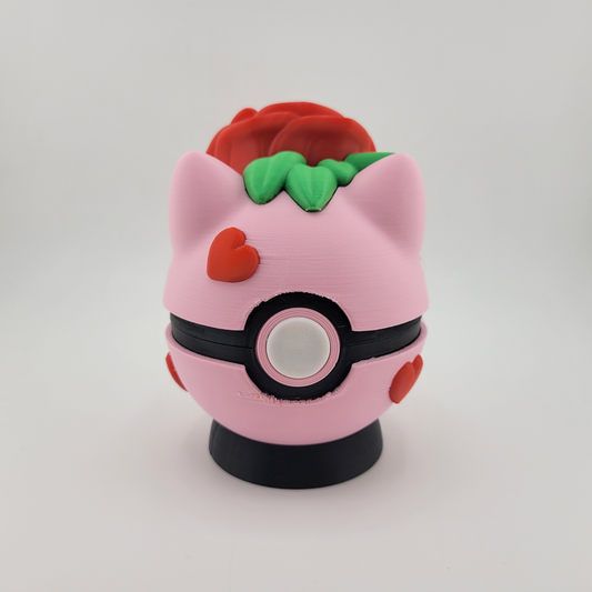 Rose Bulbasaur Pokéball with pink and red rose-inspired design, featuring Bulbasaur motifs.