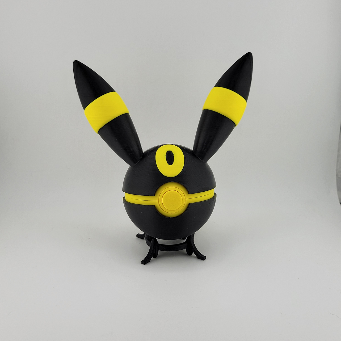 Umbreon Pokeall toy featuring black and yellow design, 3D printed collectible.