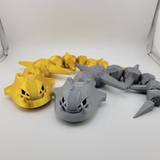 Articulated Steelix toy in gold and gray versions on display.