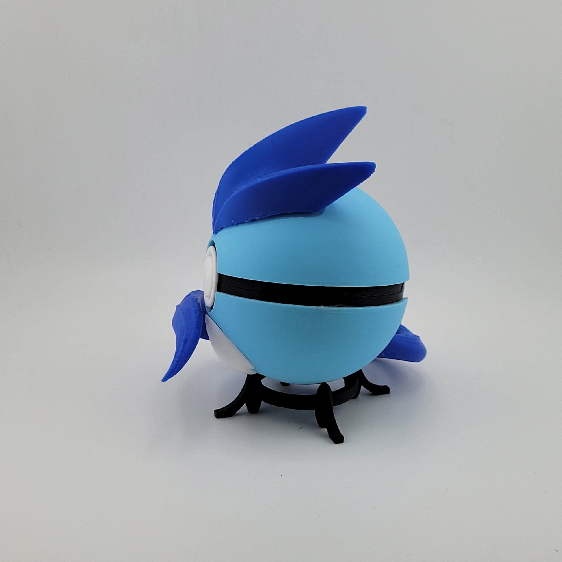 3D printed Articuno-themed Pokeball made of durable PLA plastic, featuring blue wings and tail accents, handcrafted collectible.