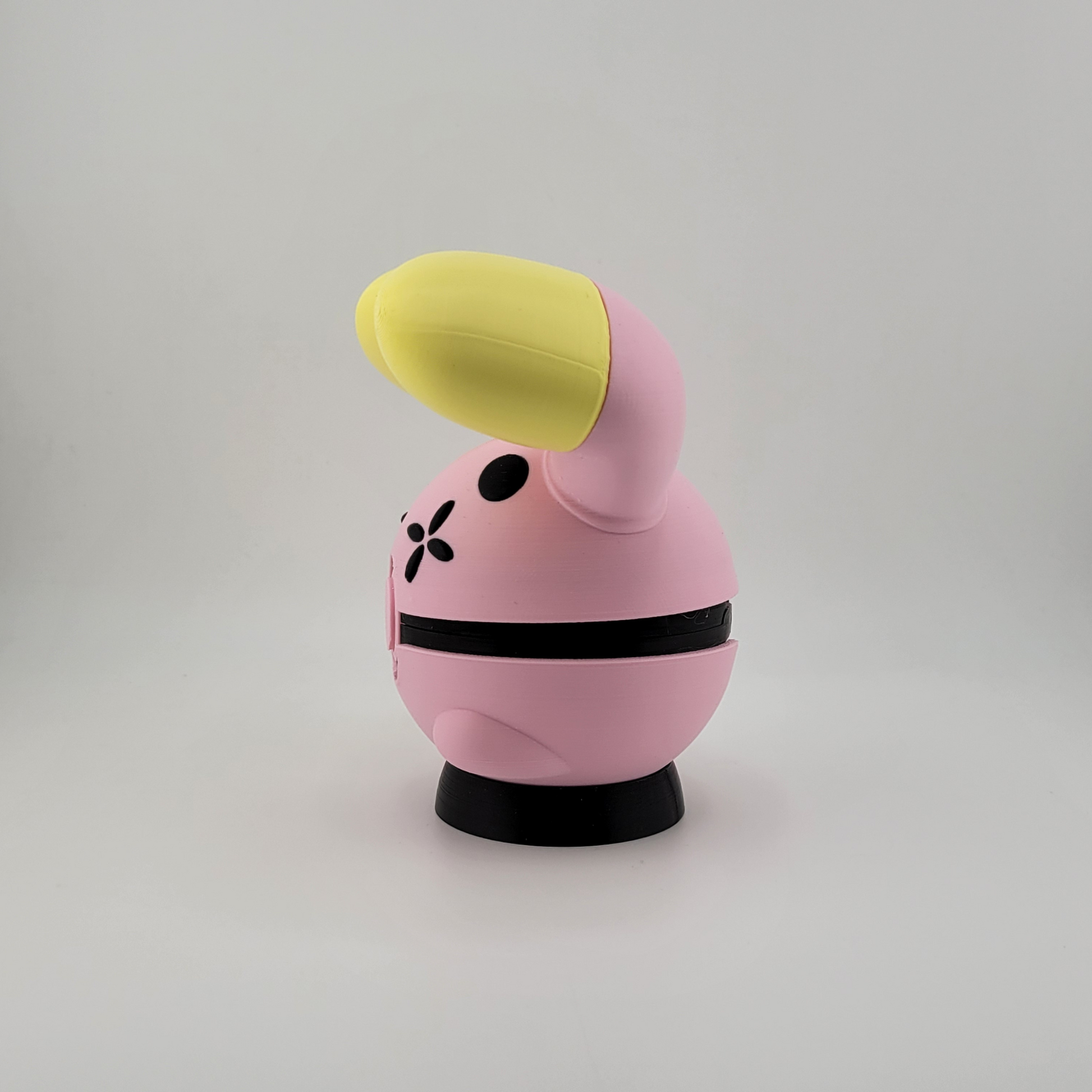 Whismur-themed Poké Ball pink and yellow 3D printed Poké Ball with oversized ears.