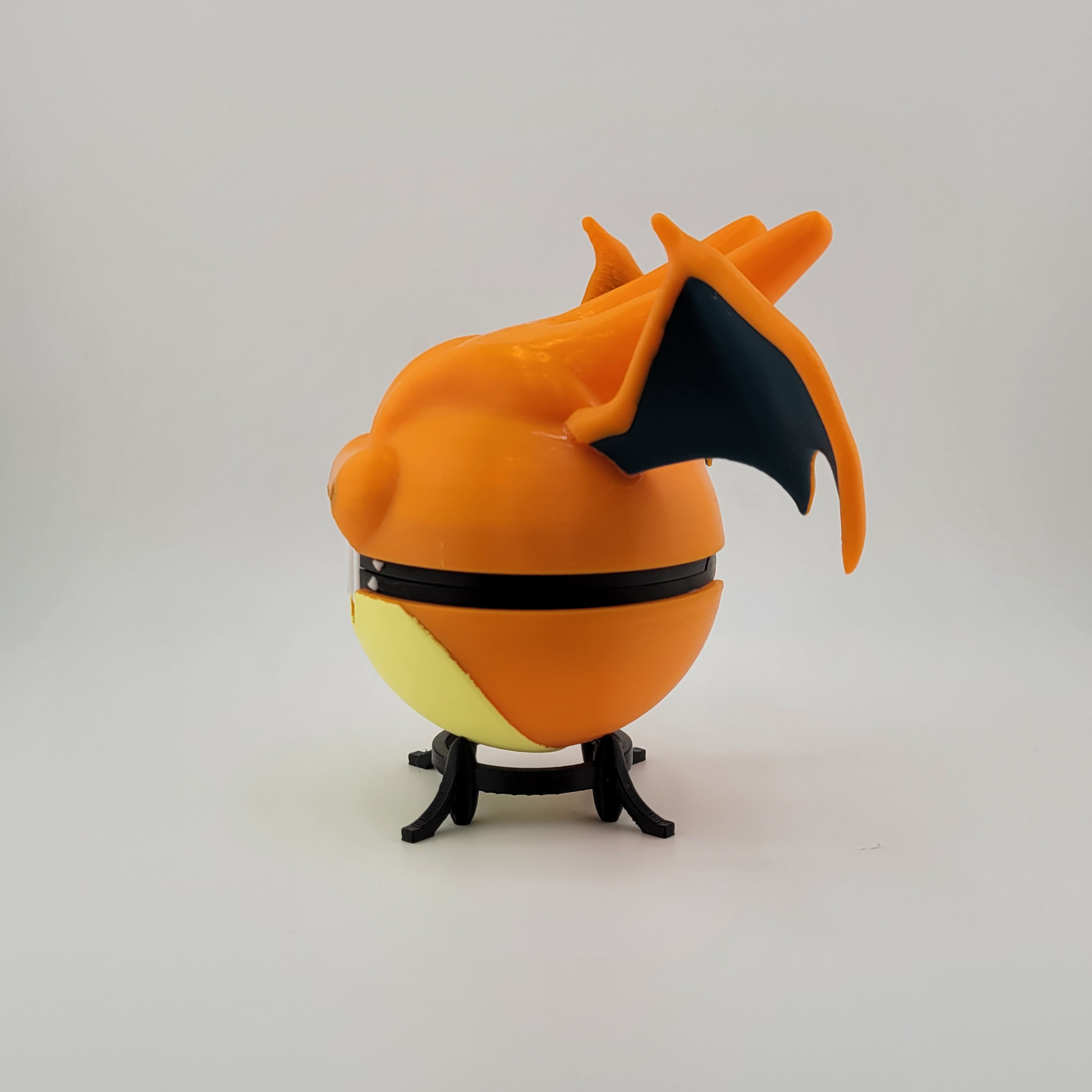Charizard Pokeball with 3D printed detail and sturdy PLA construction, inspired by Pokémon's Charizard.