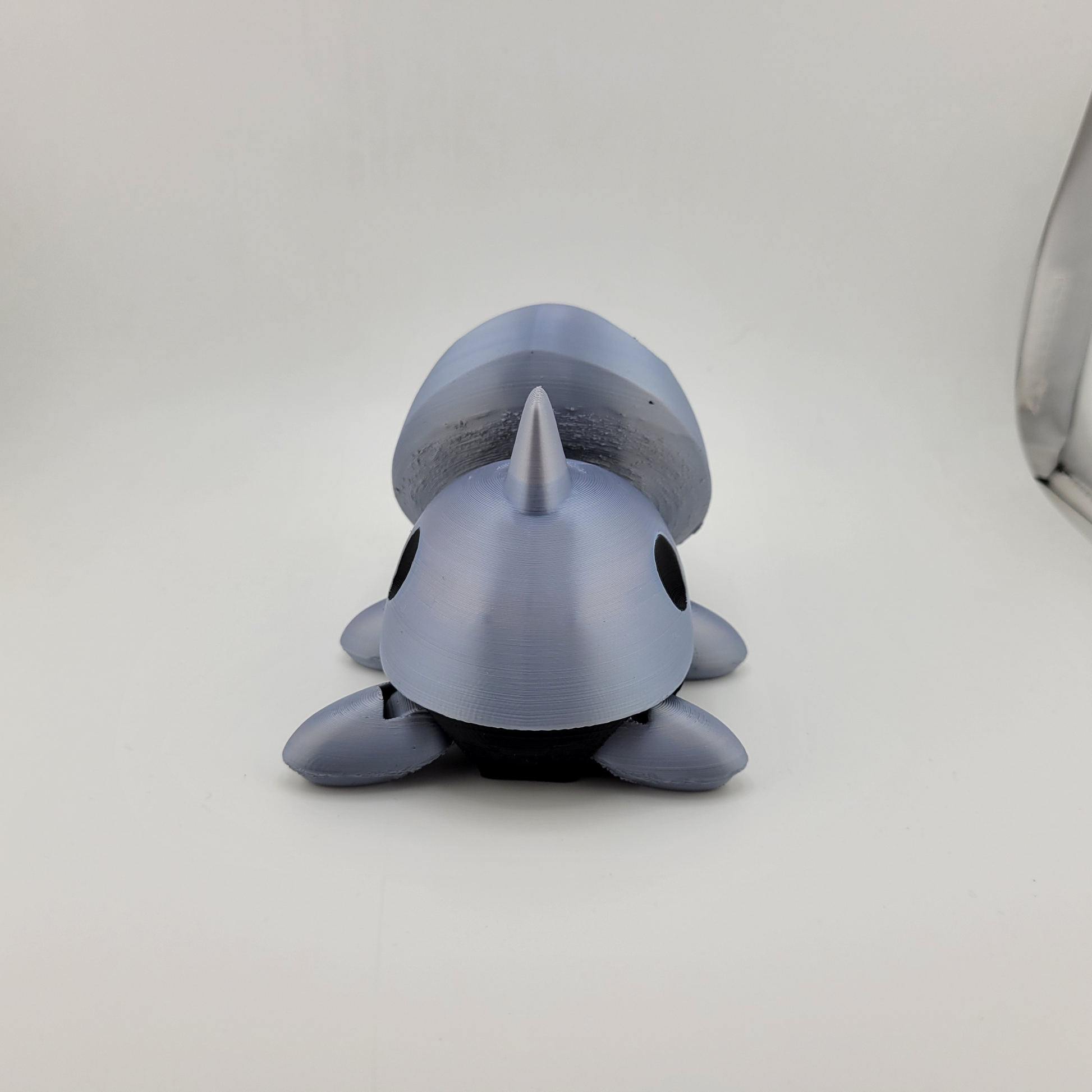 Detailed Articulated Aron Pokémon action figure with articulated limbs, featuring a metallic body and rock shell, ideal for collectors and fans.