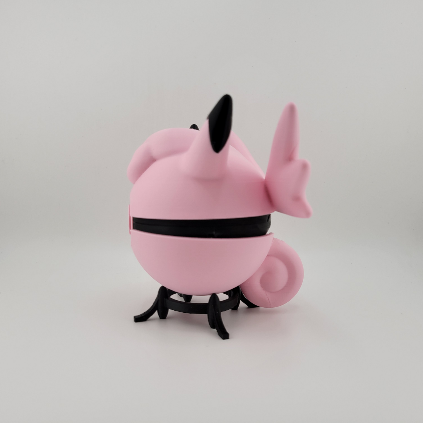 Clefable-themed Pokéball, 3D printed, pink and black design, open latch, held in hand.