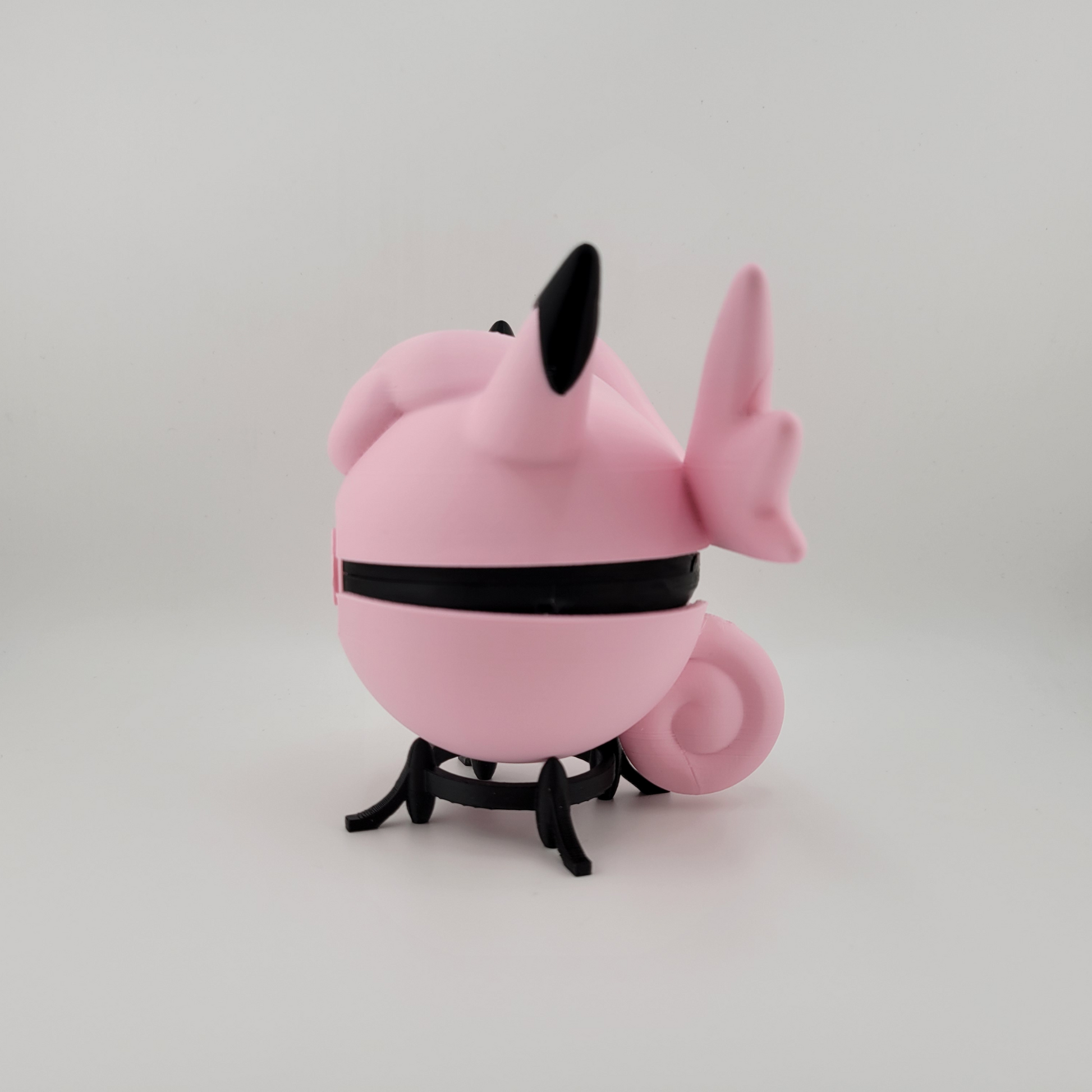 Clefable-themed Pokéball, 3D printed, pink and black design, open latch, held in hand.