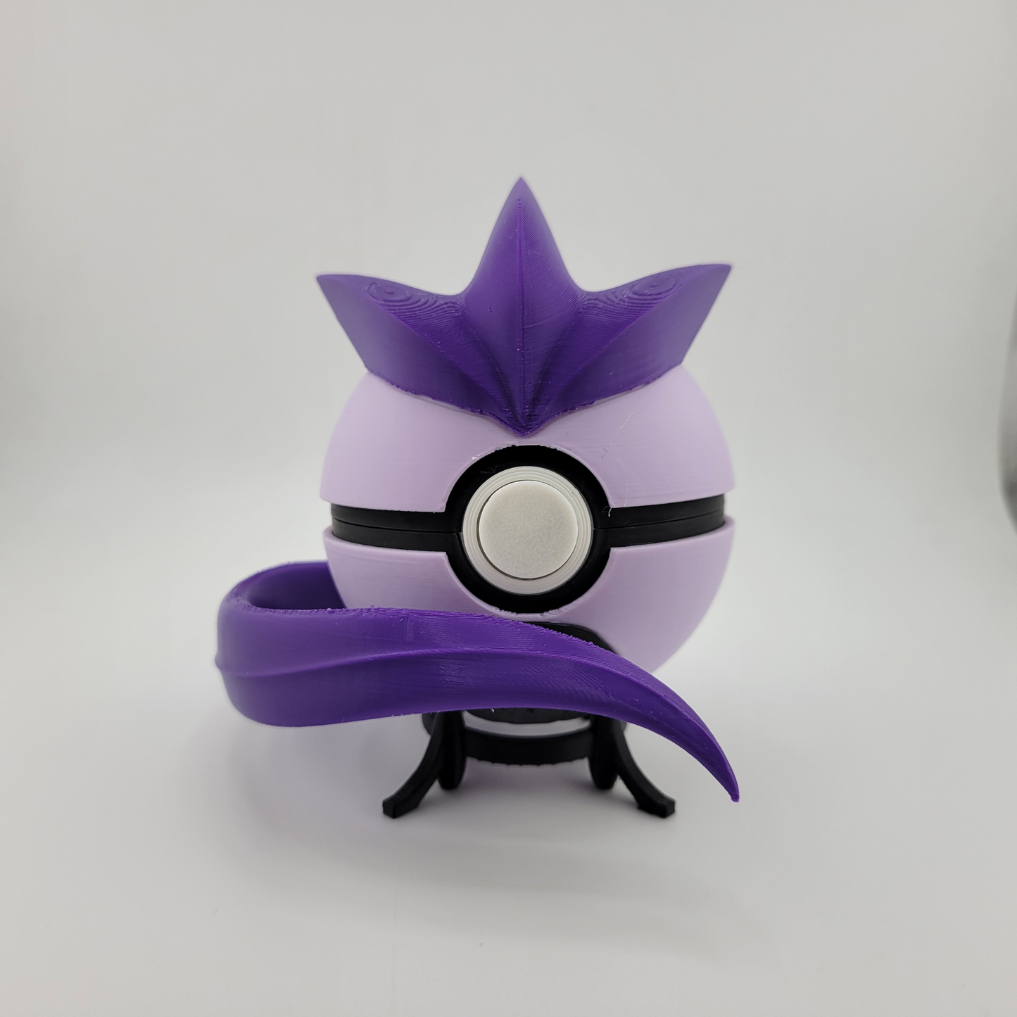 3D printed Articuno-themed Pokeball in purple and lavender with a star-shaped crown and tail detail on a small black stand.