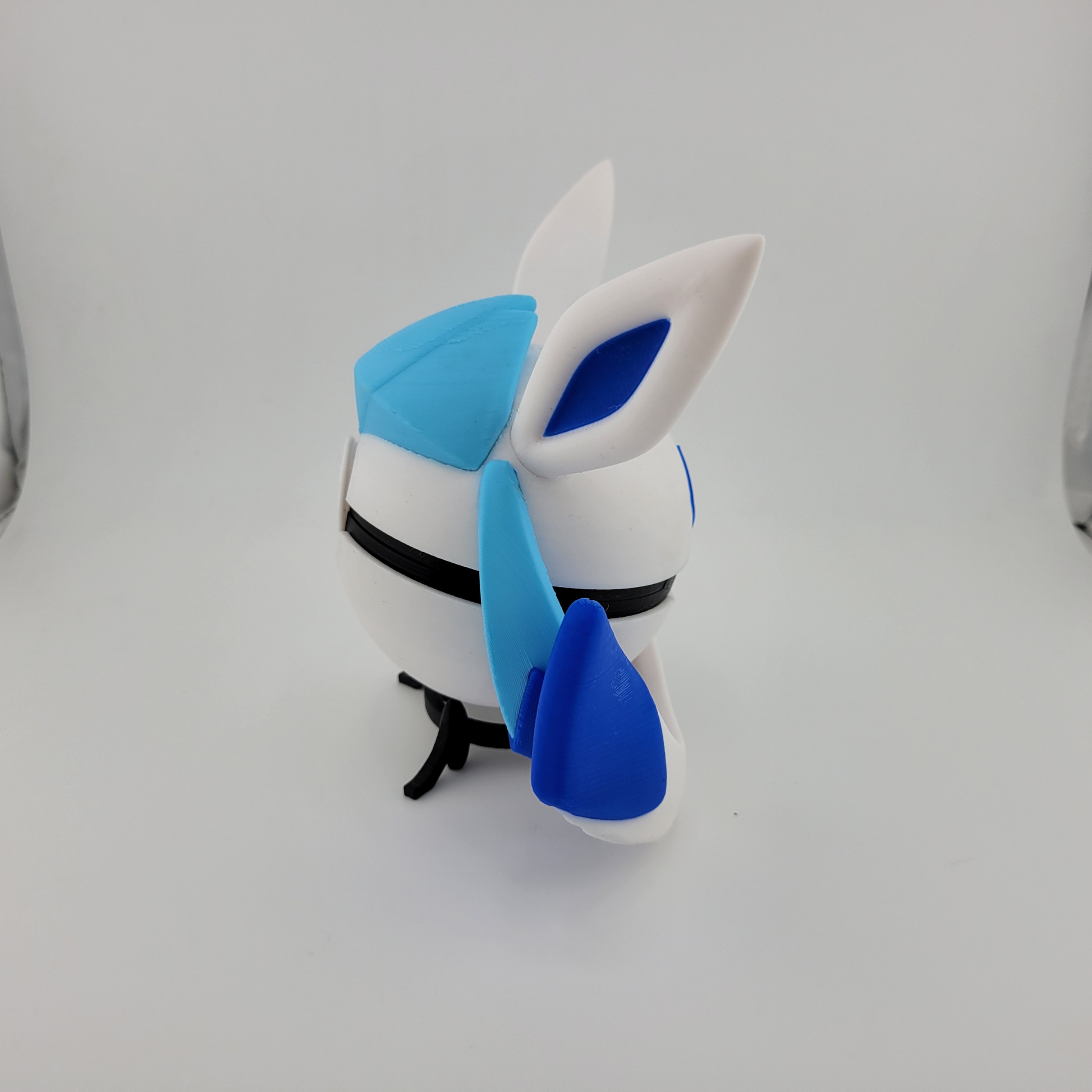 3D printed Glaceon-themed Poké Ball with icy blue and white design and snowflake-inspired elements.