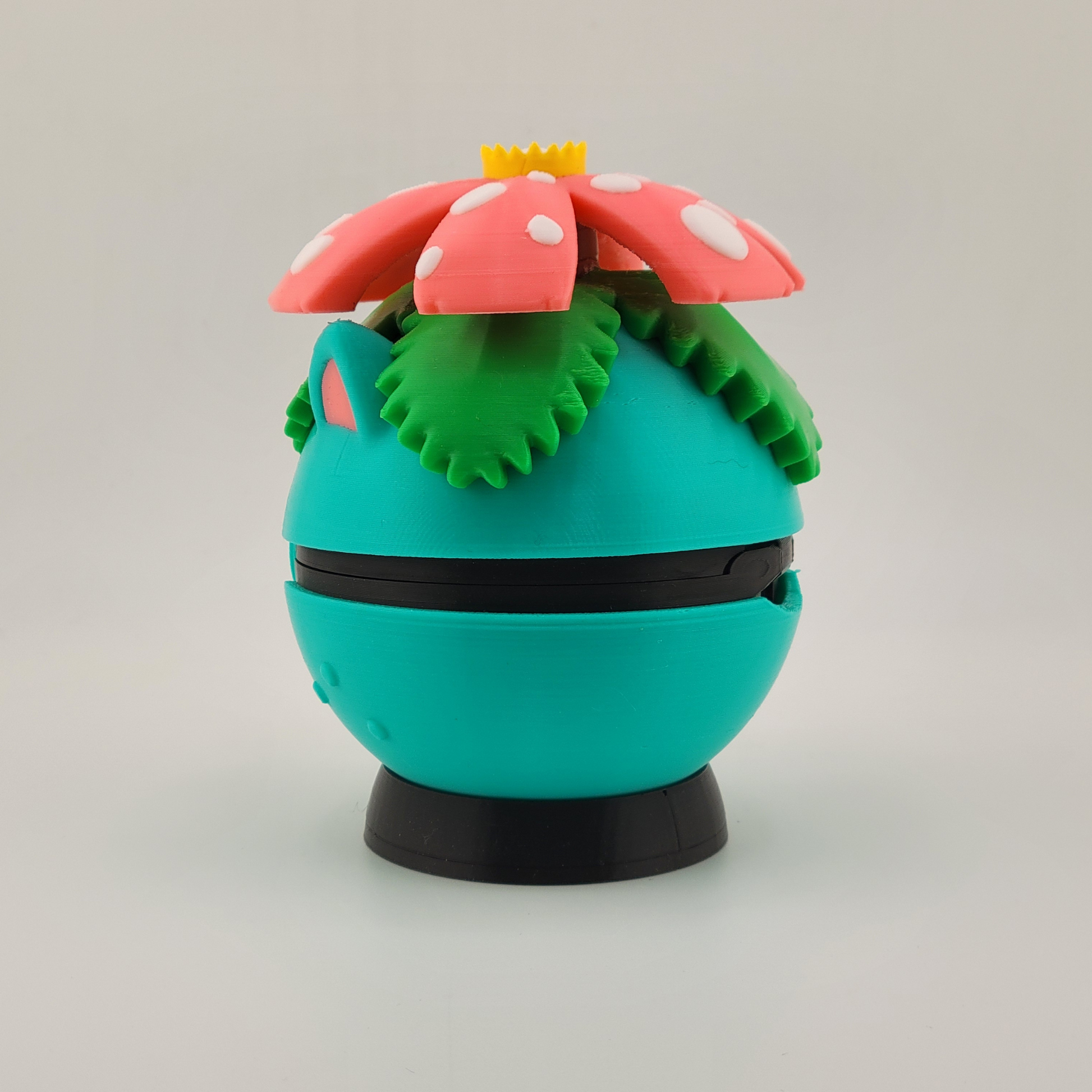Venusaur-themed 3D printed Poké Ball with tropical flower design on top, featuring earthy colors and lush details.