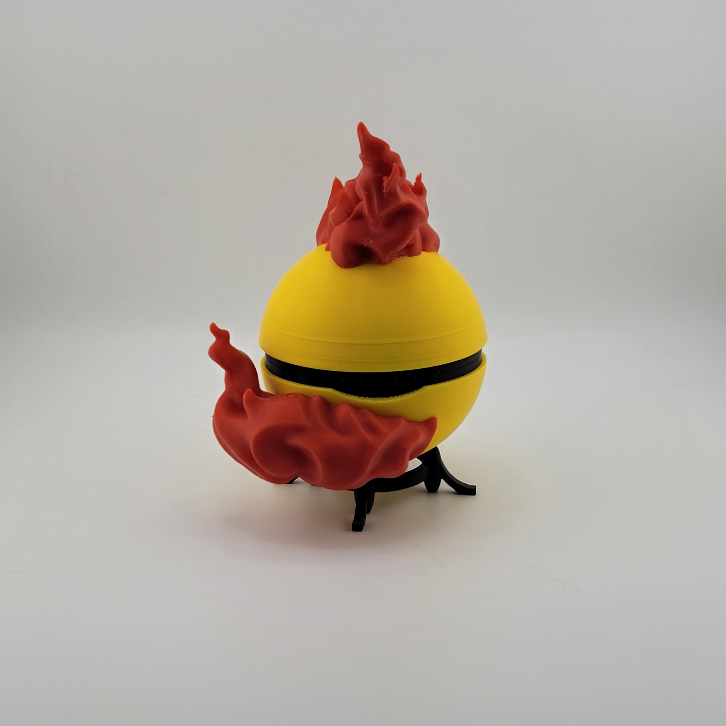 Legendary Moltres Pokeball with fiery design, 3D printed collectible made from durable PLA, featuring a unique latch mechanism.