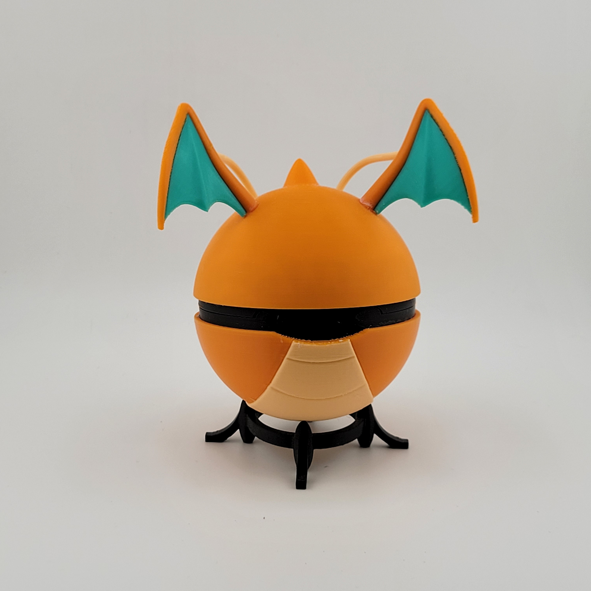 Dragonite-themed Poké Ball with orange hues and wing details, 3D printed collectible.