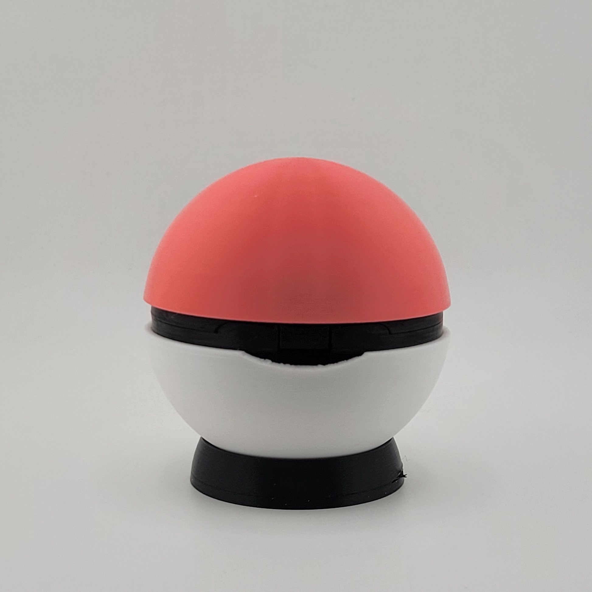 3D printed Loveball with pink and white design, heart center, displayed on stand.