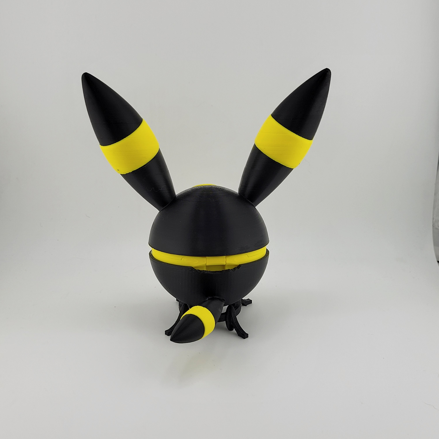 3D printed Umbreon Pokeball with black and yellow ears and tail, inspired by the Dark-type Pokémon Umbreon.
