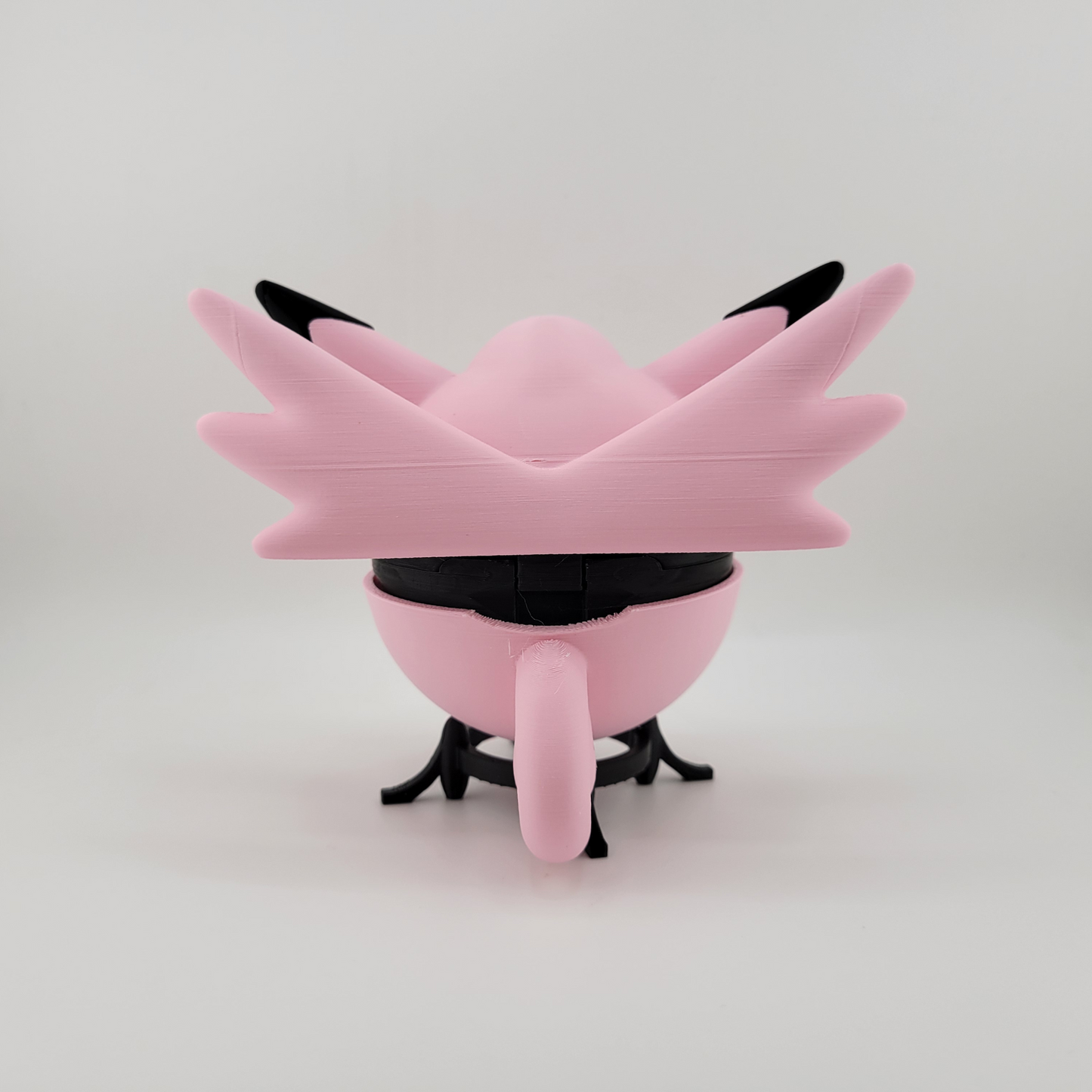 Clefable-themed Pokéball, 3D printed, pink and black design, open latch, held in hand.