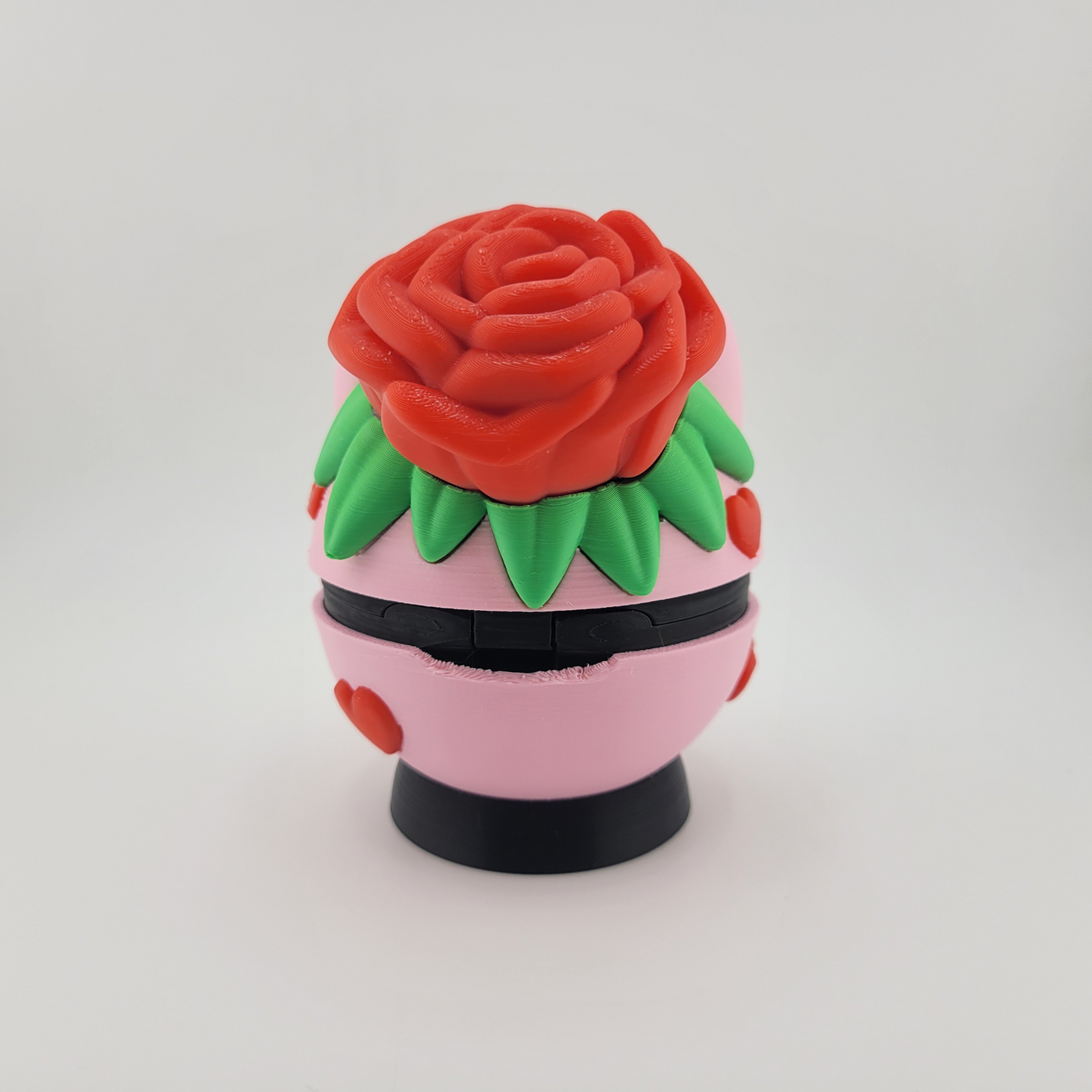 Rose Bulbasaur Themed Pokéball with red rose and green leaf motif on a pink base.