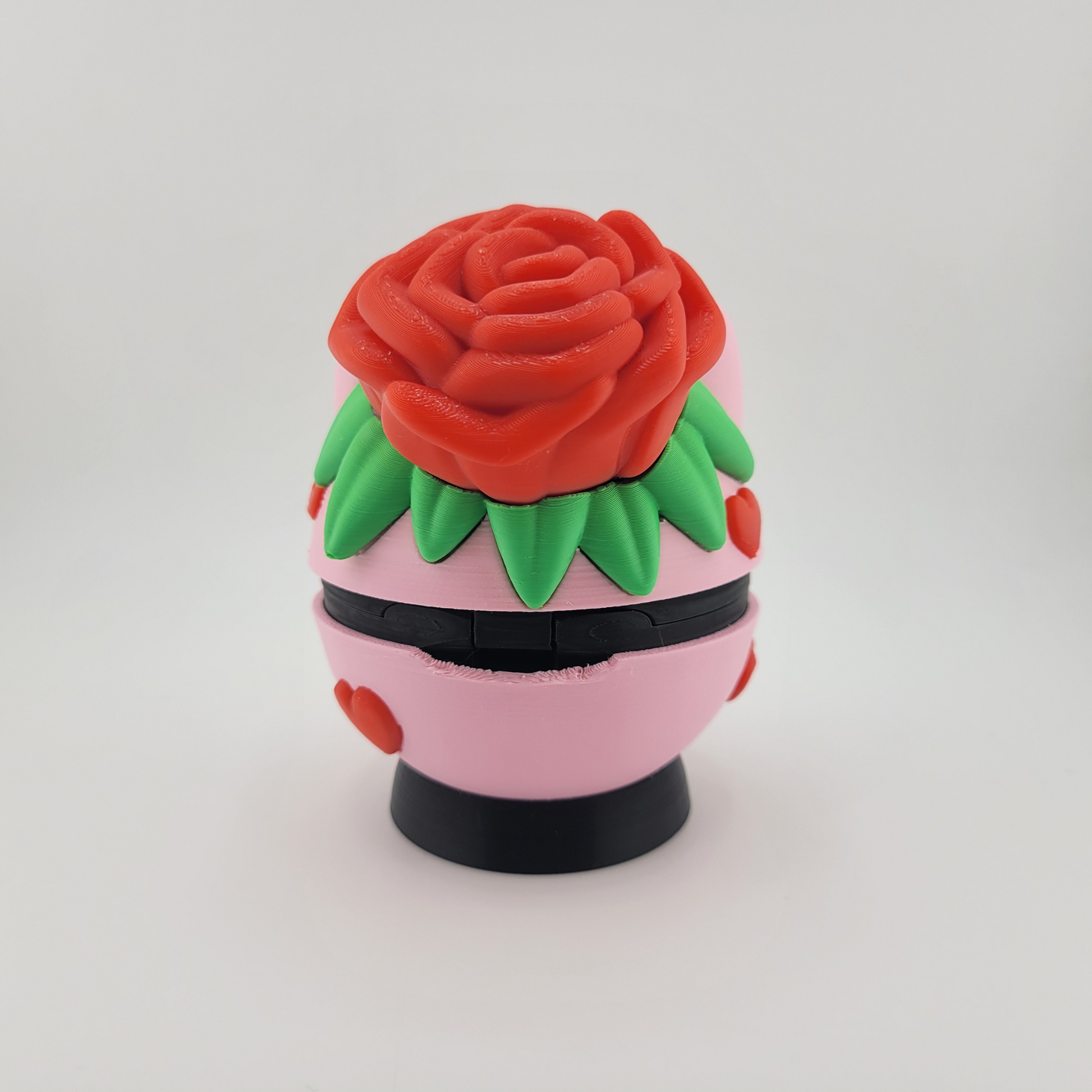 Rose Bulbasaur Themed Pokéball with red rose and green leaf motif on a pink base.