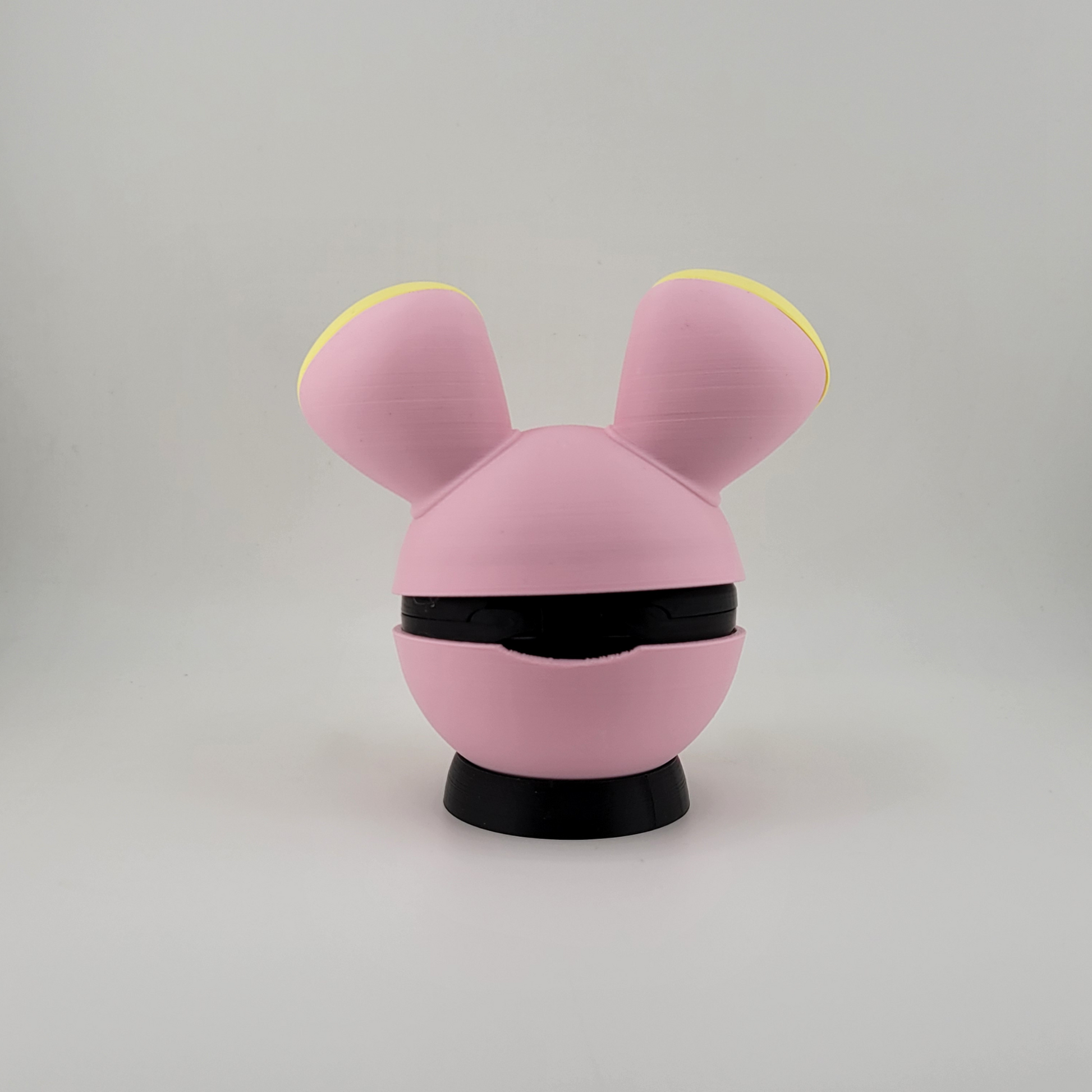 Whismur-themed Poké Ball pink and yellow 3D printed Poké Ball with oversized ears.