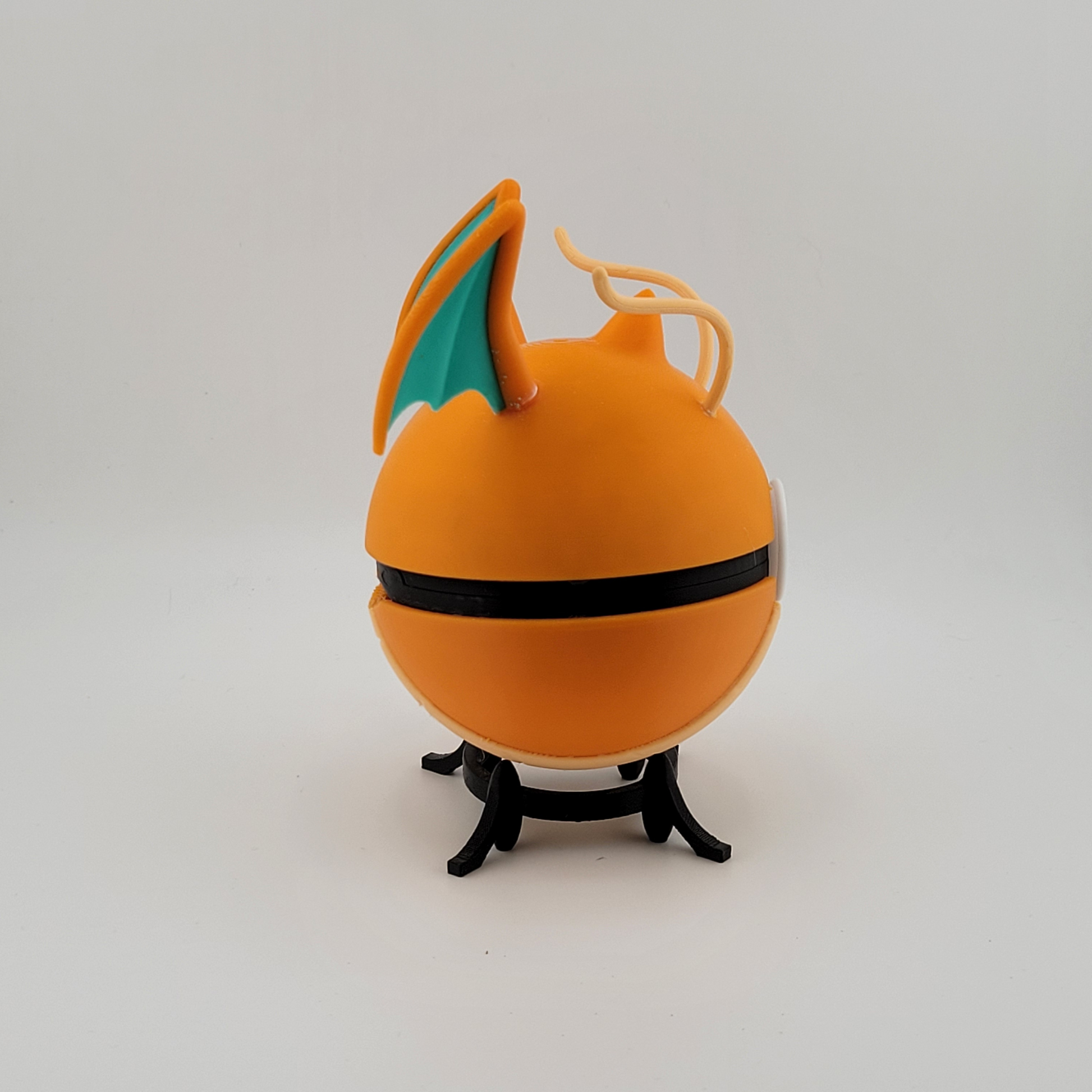 Dragonite-themed Poké Ball with orange hues and wing details, 3D printed collectible.
