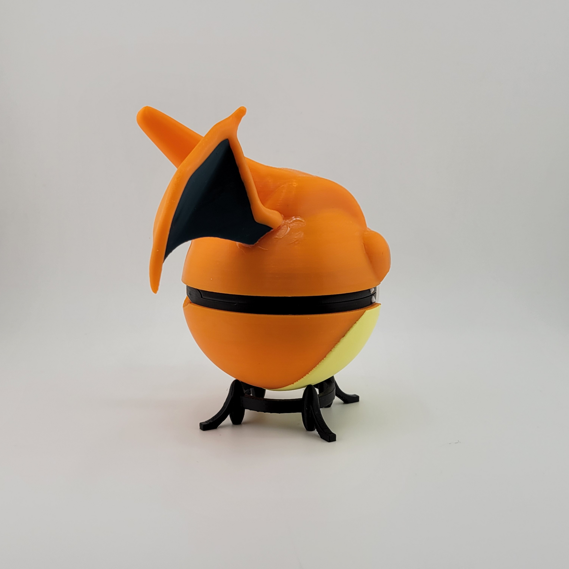 Charizard Pokeball 3D printed from PLA, featuring Charizard-inspired design.