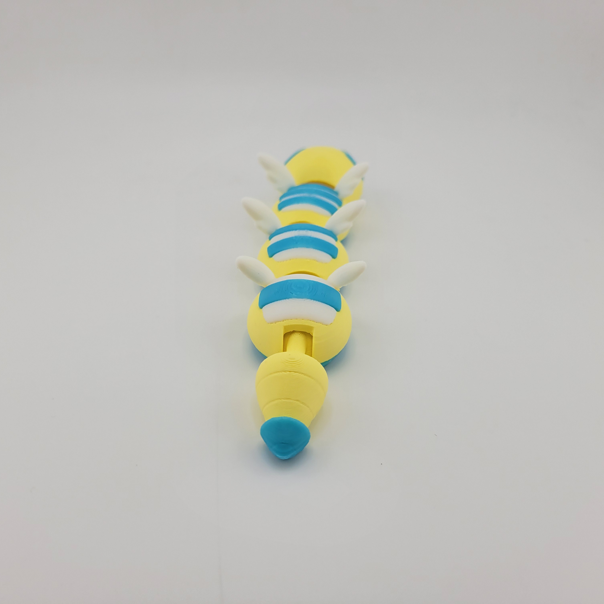 Articulated 3D printed Dudunsparce Pokémon toy with flexible joints and intricate details, showcasing its unique design.