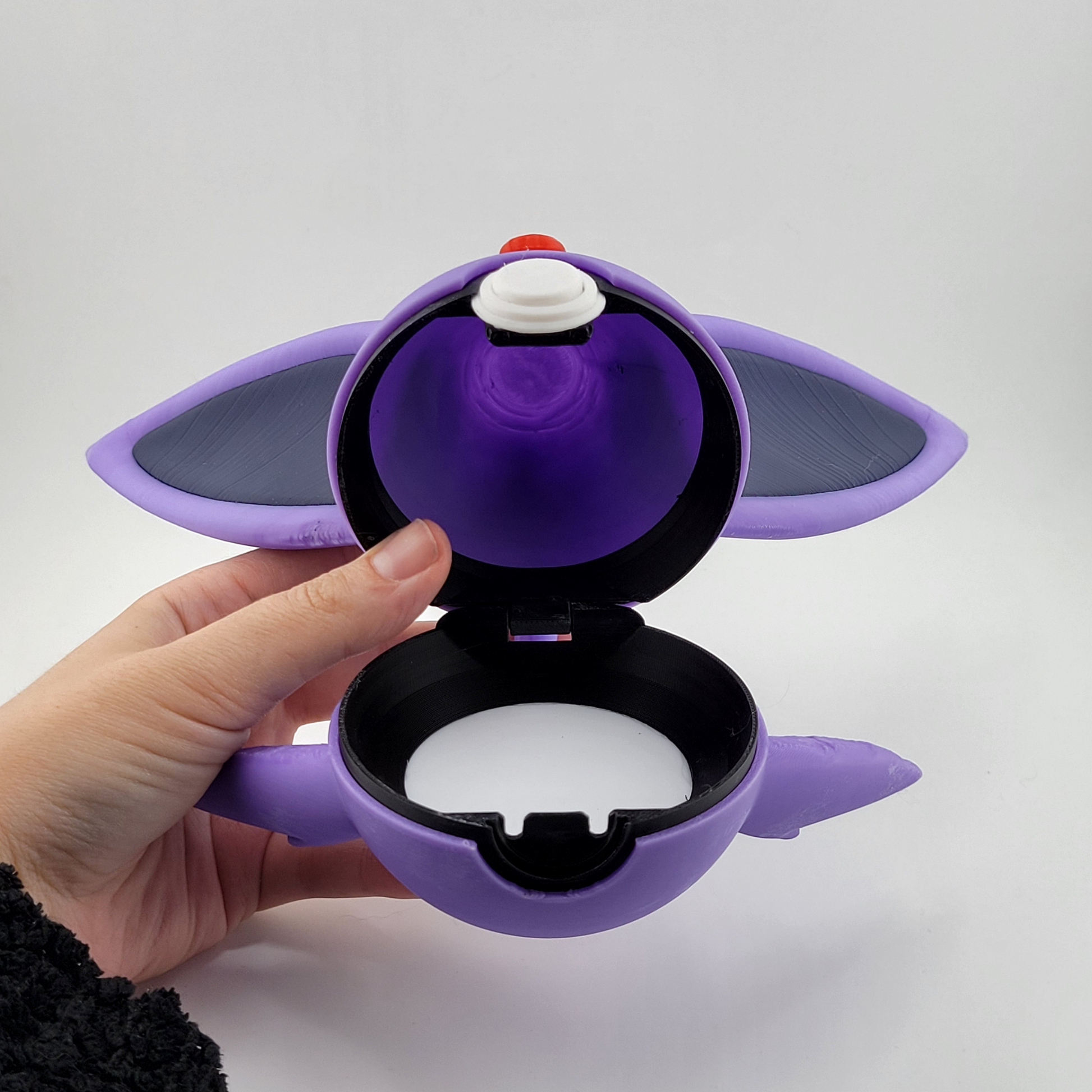 Espeon Pokeball with open latch, featuring a purple design inspired by Pokémon's Espeon.
