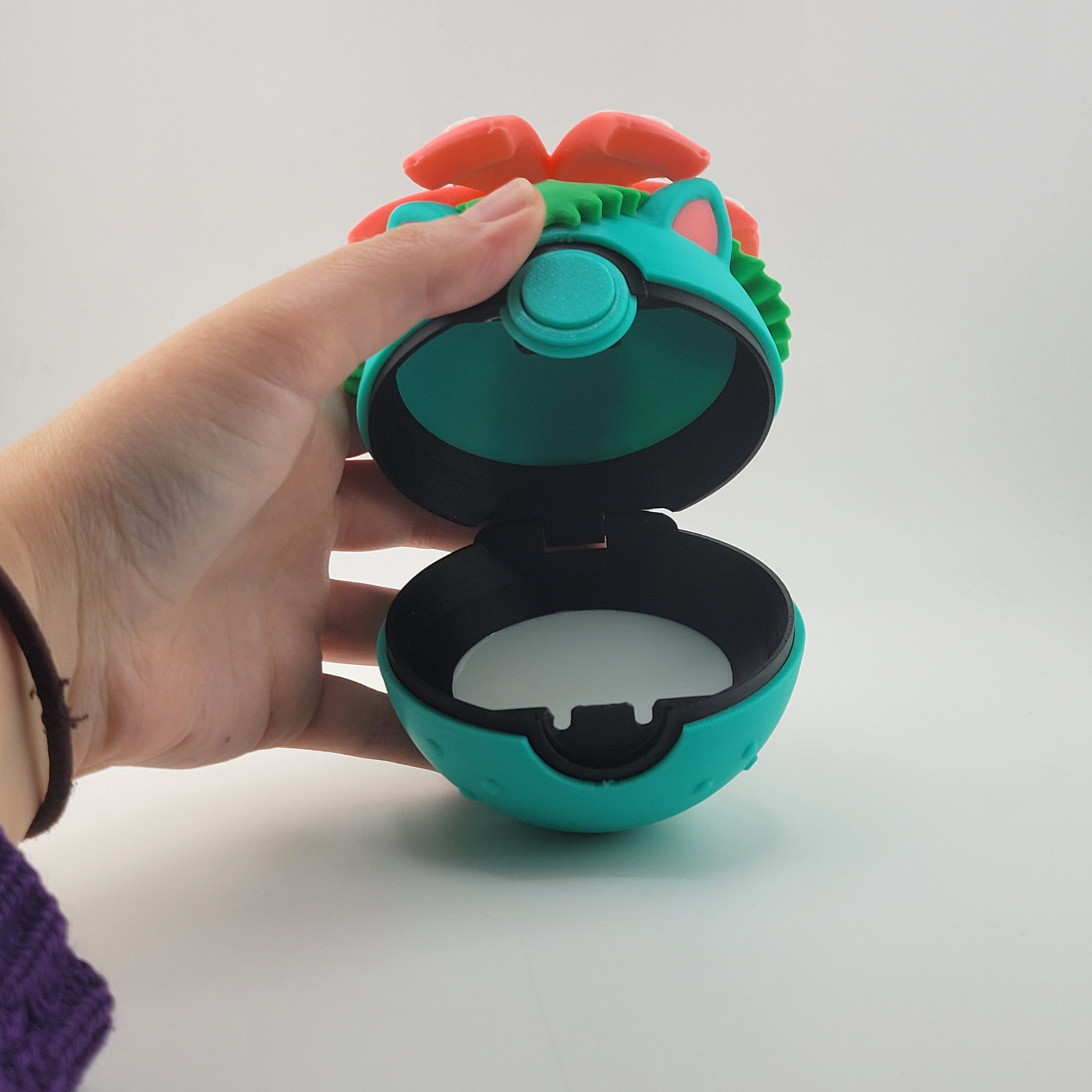 Venusaur-themed 3D printed Poké Ball with tropical flower design on top, featuring earthy colors and lush details.
