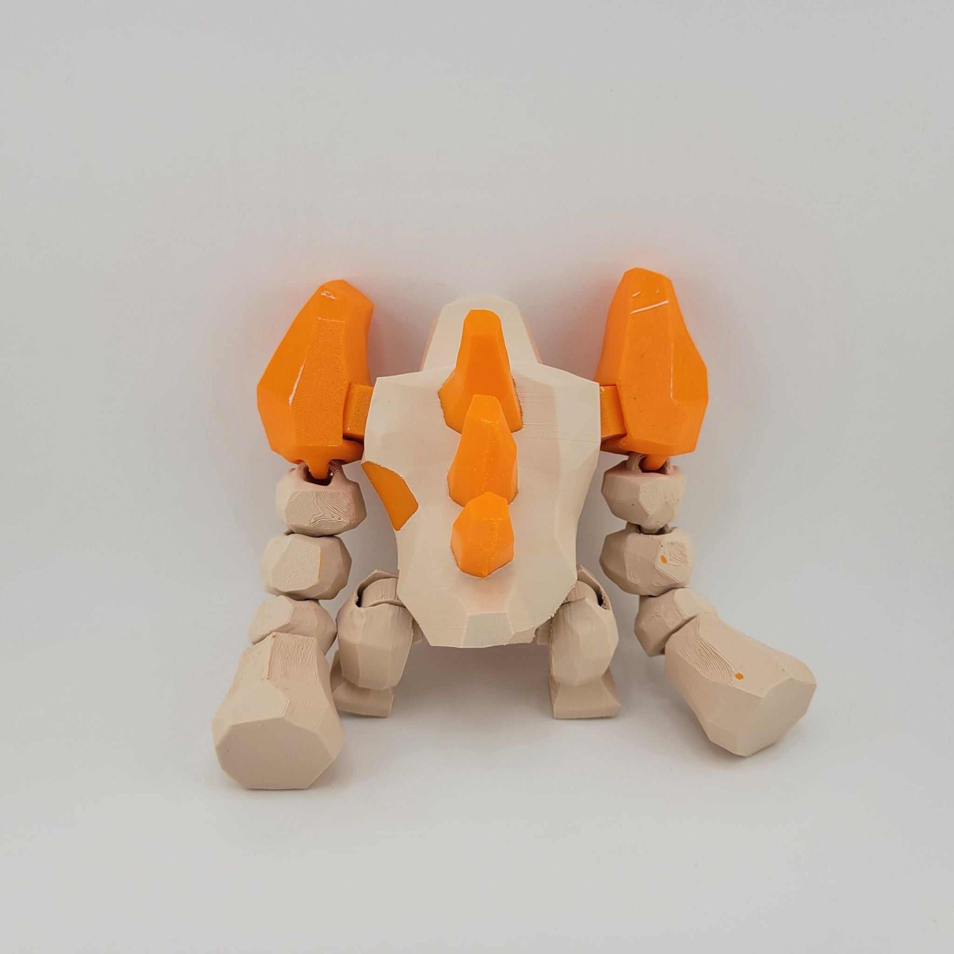 3D printed Regirock figure with articulated arms in beige and orange, standing about five inches tall, designed to resemble an ancient stone Pokémon.
