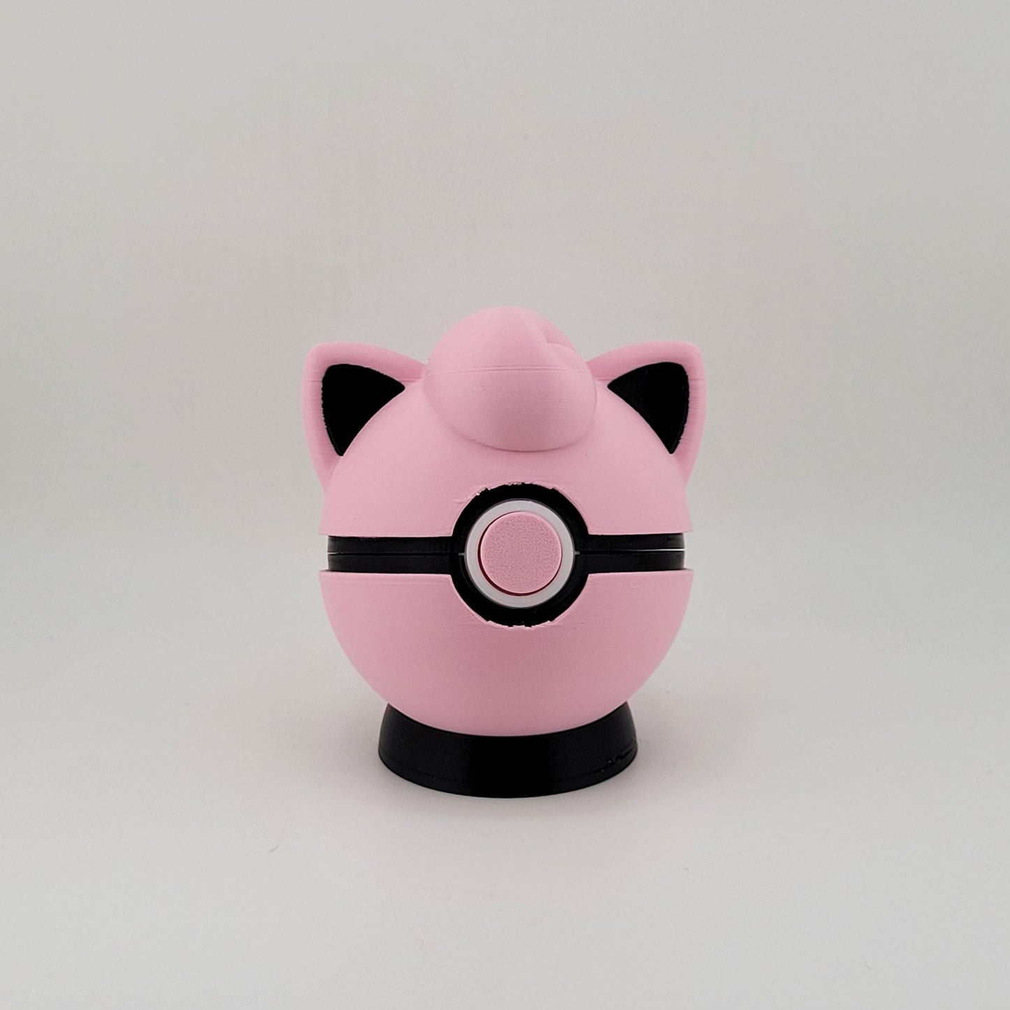 Pink Jigglypuff-themed 3D printed Pokeball with black detailing and functional latch.