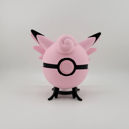 Clefable-themed Pokéball, 3D printed, pink and black design, open latch, held in hand.