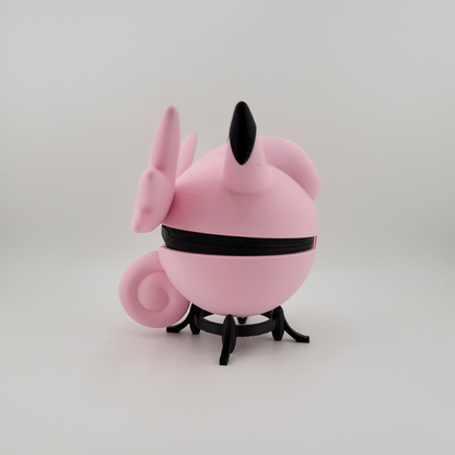 Clefable-themed Pokéball, 3D printed, pink and black design, open latch, held in hand.