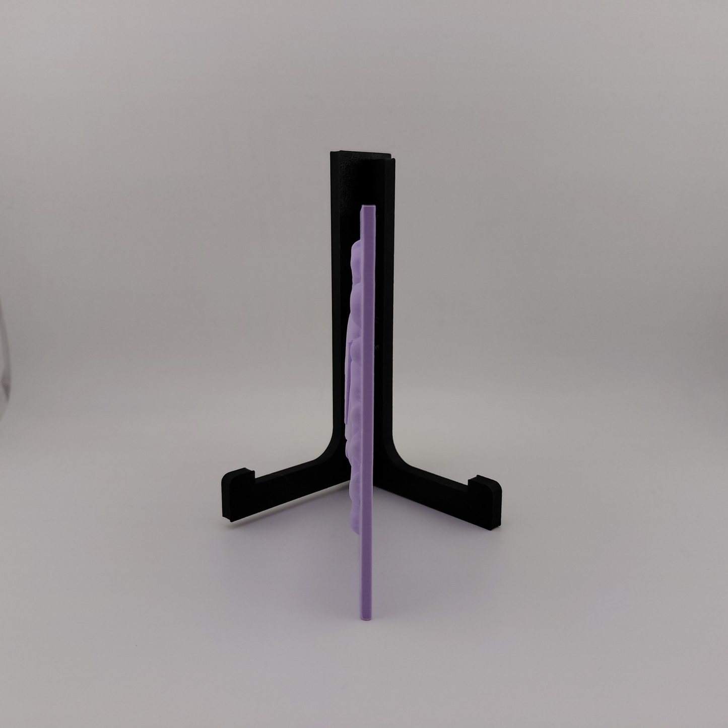 Set of three lavender 3D printed relief plaques featuring Gastly, Haunter, and Gengar inspired ghost monsters displayed on black stands against a white background. Each square plaque has raised detailed artwork and comes with its own stand for desk, shelf, or gaming room decor. Available individually or as a matching set for collectors and fans of spooky monster-inspired decor.