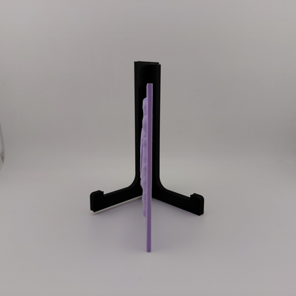 Set of three lavender 3D printed relief plaques featuring Gastly, Haunter, and Gengar inspired ghost monsters displayed on black stands against a white background. Each square plaque has raised detailed artwork and comes with its own stand for desk, shelf, or gaming room decor. Available individually or as a matching set for collectors and fans of spooky monster-inspired decor.