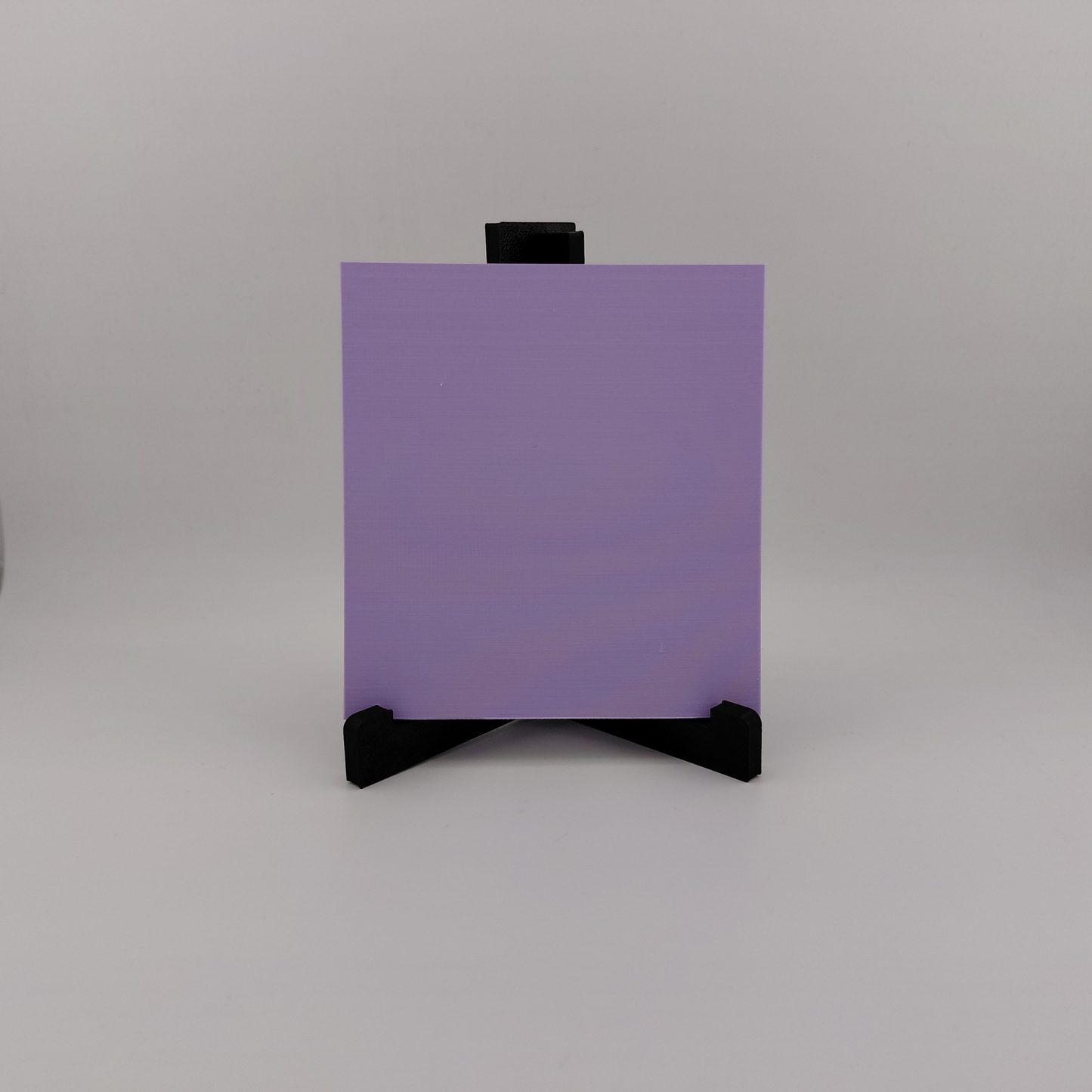 Set of three lavender 3D printed relief plaques featuring Gastly, Haunter, and Gengar inspired ghost monsters displayed on black stands against a white background. Each square plaque has raised detailed artwork and comes with its own stand for desk, shelf, or gaming room decor. Available individually or as a matching set for collectors and fans of spooky monster-inspired decor.