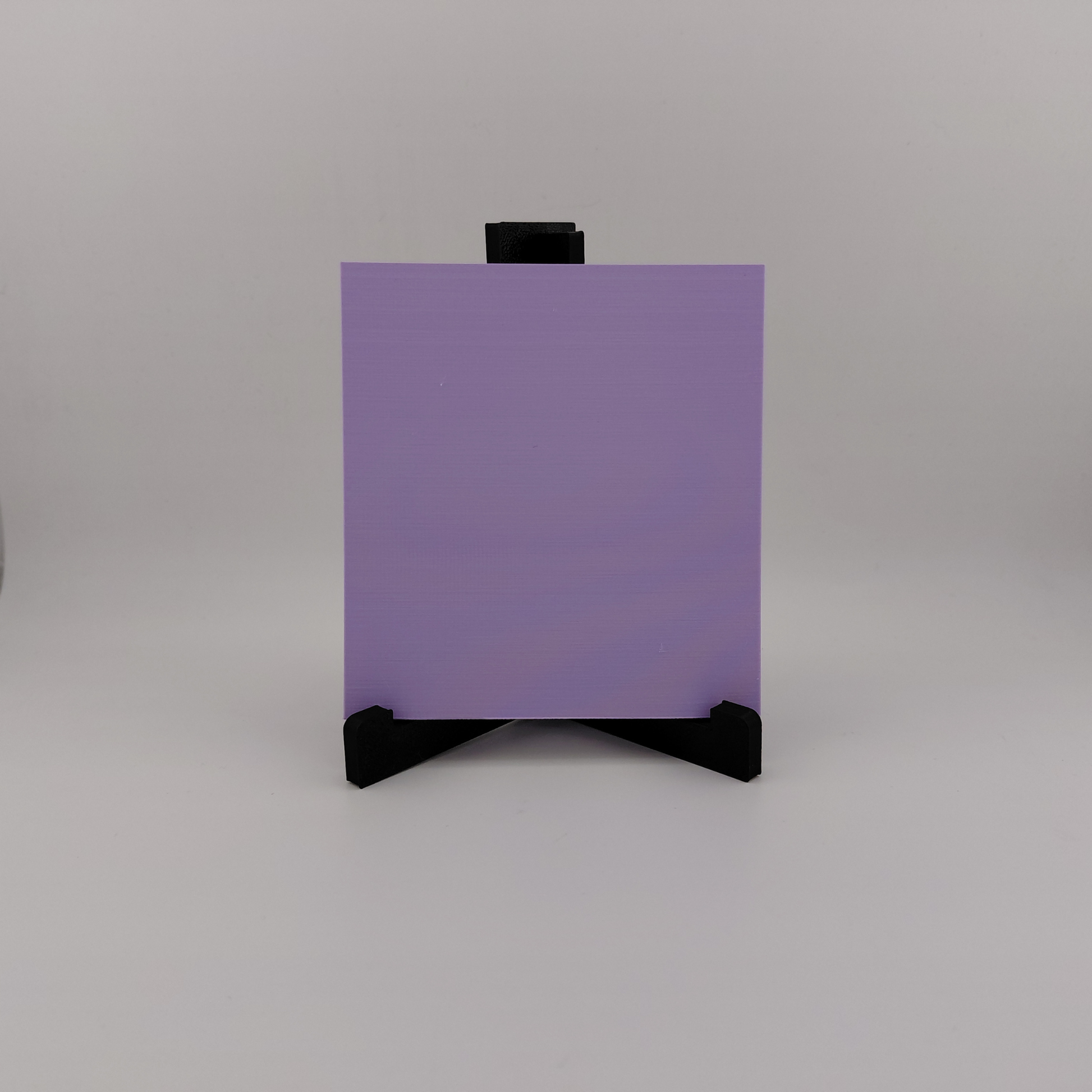 Set of three lavender 3D printed relief plaques featuring Gastly, Haunter, and Gengar inspired ghost monsters displayed on black stands against a white background. Each square plaque has raised detailed artwork and comes with its own stand for desk, shelf, or gaming room decor. Available individually or as a matching set for collectors and fans of spooky monster-inspired decor.