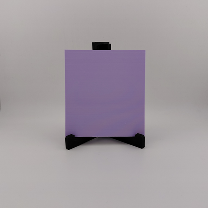 Set of three lavender 3D printed relief plaques featuring Gastly, Haunter, and Gengar inspired ghost monsters displayed on black stands against a white background. Each square plaque has raised detailed artwork and comes with its own stand for desk, shelf, or gaming room decor. Available individually or as a matching set for collectors and fans of spooky monster-inspired decor.