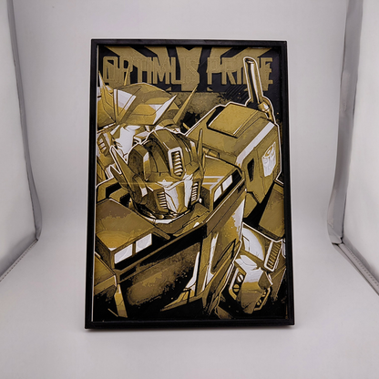 Layered 3D printed Optimus Prime wall art inspired by a classic Transformers comic cover. Created using Chroma Canvas technology with textured depth, lightweight PLA construction, black frame, and gold, black, and white color palette. Can be displayed on a desk using the built-in stand or hung on a wall. Ideal for Transformers collectors, comic fans, gaming rooms, and nerd office décor.