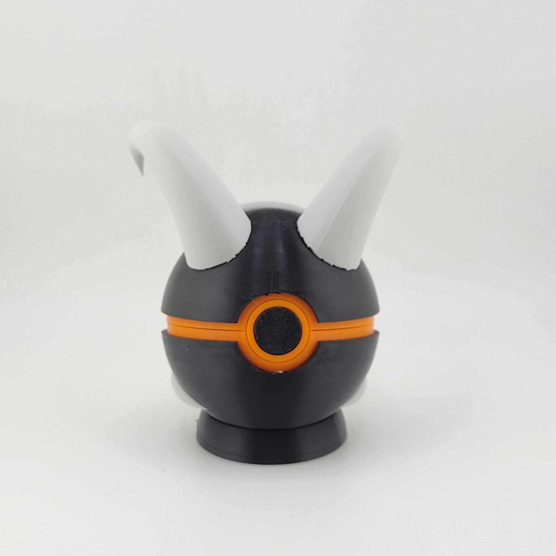 3D printed Houndoom Ball with black and orange design and white horns inspired by Pokémon