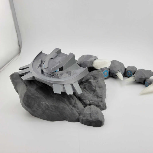 3D printed articulated Mega Steelix Pokémon figure in gray on black base with detailed segments and claws
